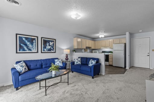 a living room with blue couches and a coffee table