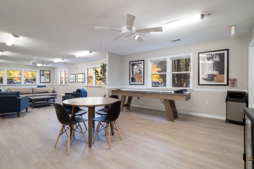 a resident clubhouse with a pool table and couches