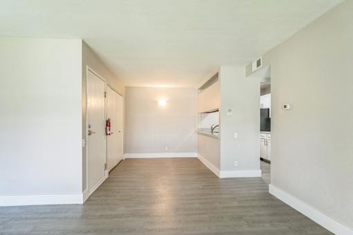 A room with a wooden floor and white walls.