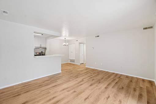 A room with wooden floors and white walls.