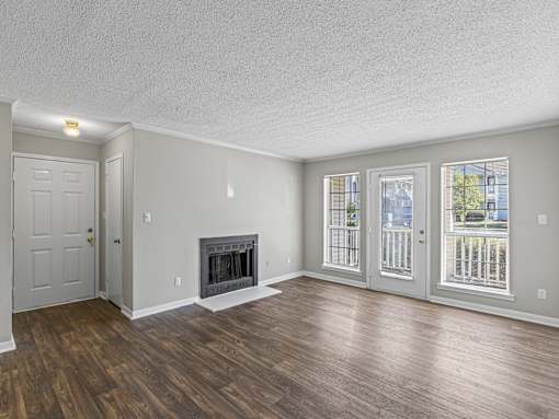 Room with fireplace and glass doors at Park at Meadow Ridge Montgomery AL