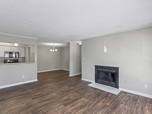 Living room with fireplace and wood floors at Park at Meadow Ridge Montgomery AL