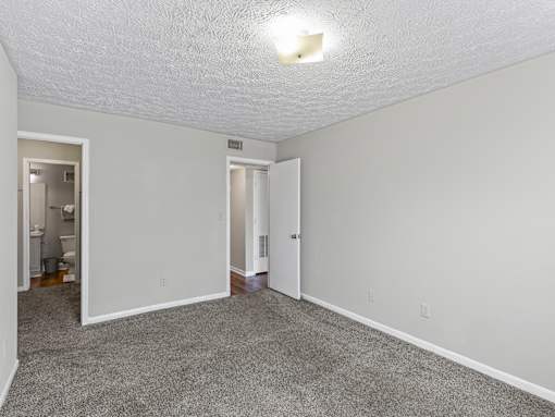 Carpeted room with doorway at Stratford Village Montgomery AL