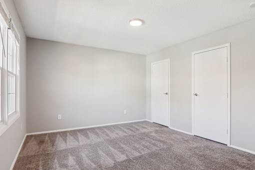 A room with a carpeted floor and white walls.