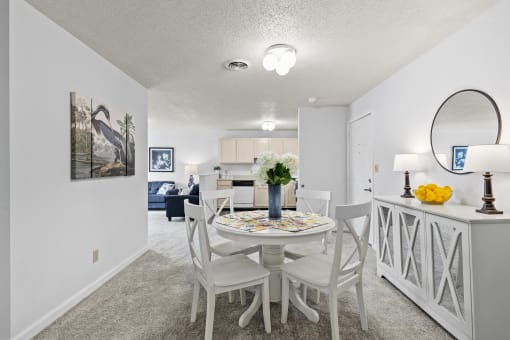 a dining room with a table and chairs and a living room