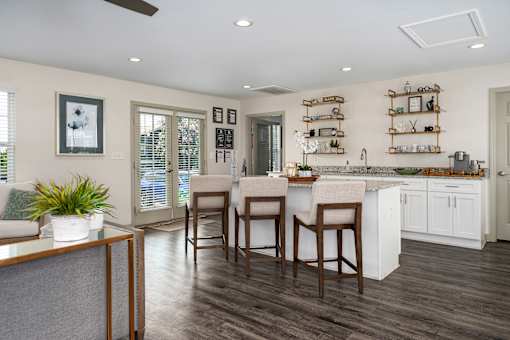 A kitchen with a bar area and a dining table.