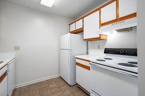 Kitchen with wood cabinets and appliances at Arbours at Victoria Place Prattville AL