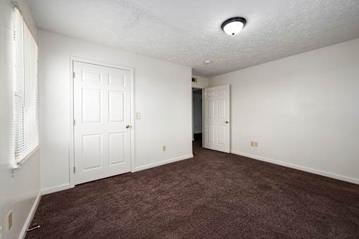 Bedroom with carpet at Arbours at Victoria Place Prattville AL