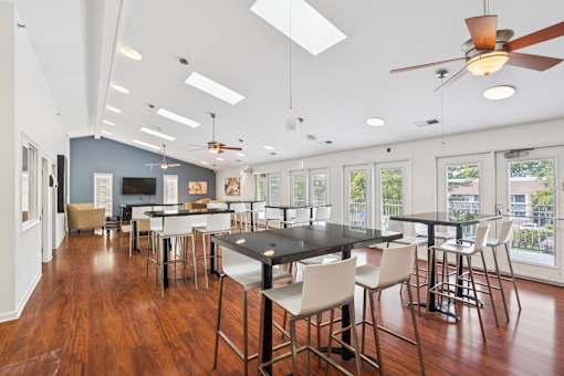 A modern dining room with a black table and chairs.