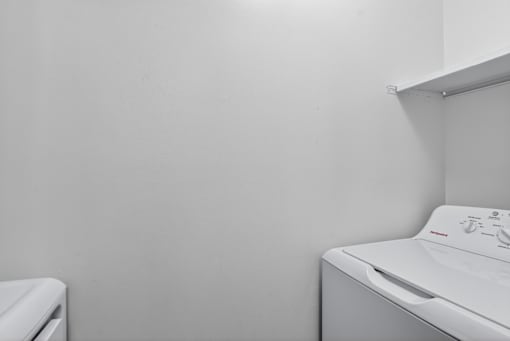 A white washing machine in a laundry room.