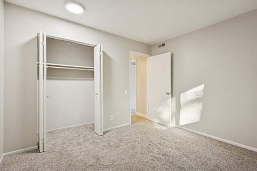 A white room with a bunk bed and a door.