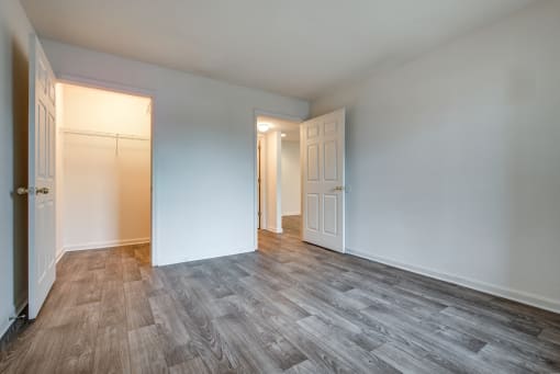 a living room with a wood floor and white walls and doors