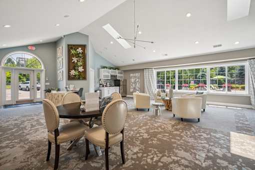 A dining room with a table and chairs.