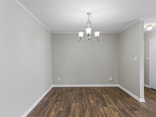 Room with wood floors and chandelier at Park at Meadow Ridge Montgomery AL