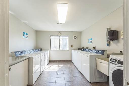 A laundry room with washers and dryers.