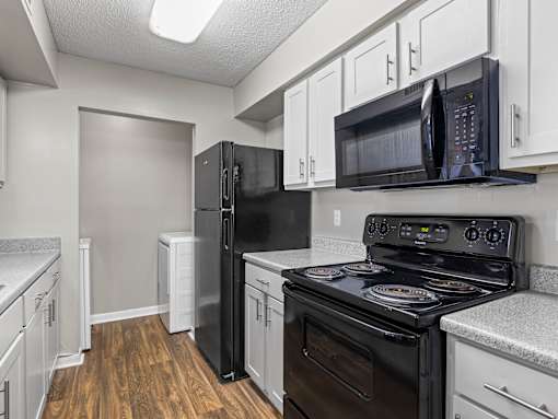 Kitchen with black appliances at Park at Meadow Ridge Montgomery AL
