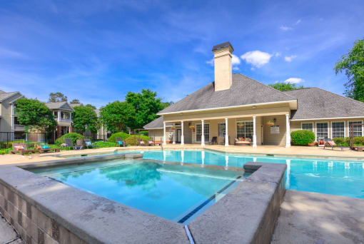 a swimming pool with a house in the background