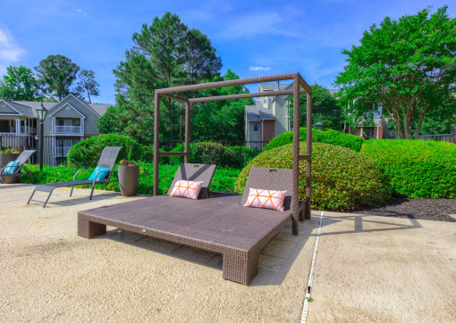 a patio with a bench and a swing