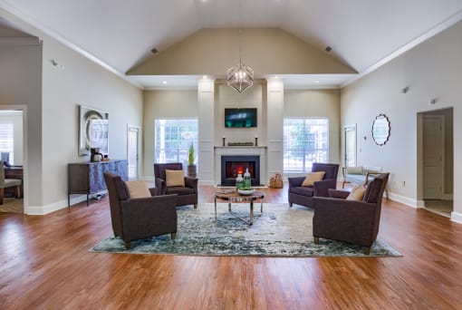 a living room with couches and chairs and a fireplace