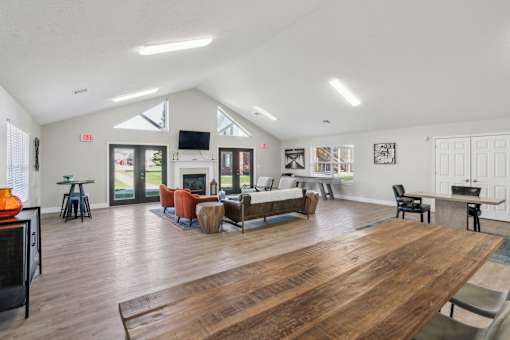 A living room with a wooden floor and a fireplace.