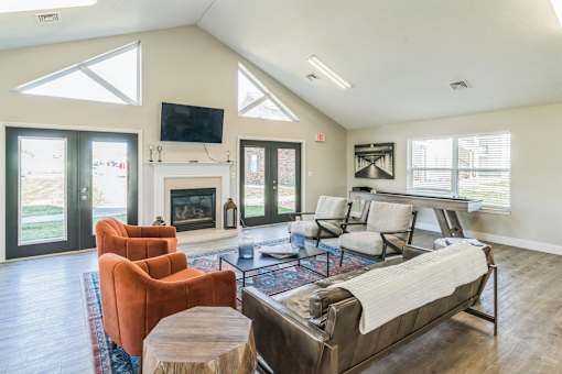 A living room with a fireplace and a television on the wall.