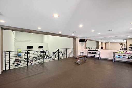 A gym with a variety of equipment including weights and exercise machines.