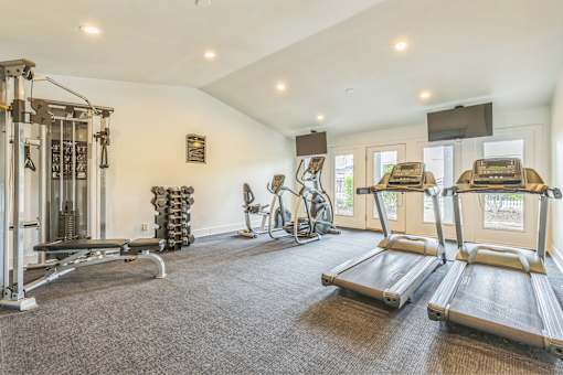 Fitness center with cardio and weights at Ashford Place Mobile AL