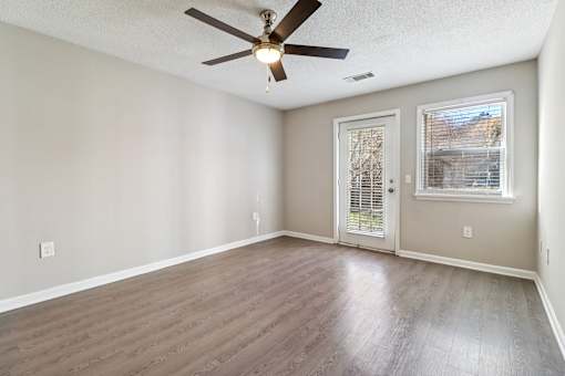 Room with hardwood floors and balcony access at Avalon Place Columbia SC