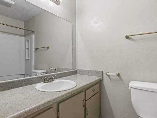A bathroom with a sink, toilet, and bathtub.