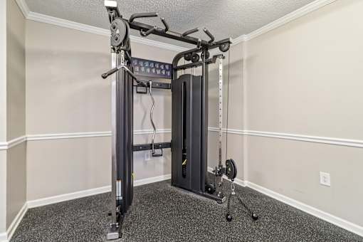 Fitness center with squat rack and bench at Avalon Place Columbia SC