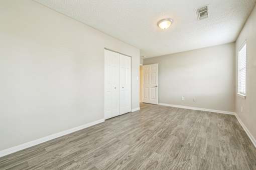 A room with a wooden floor and white walls.
