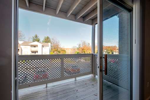 A view from a balcony looking out at a residential area.