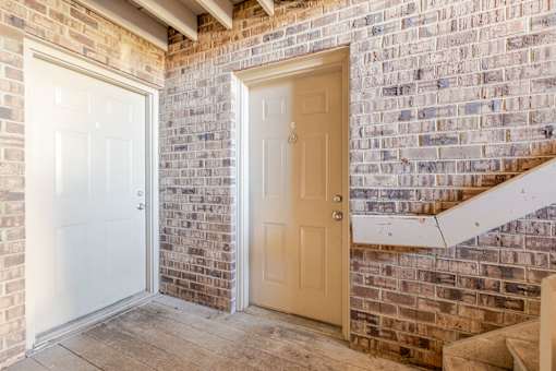 A white door is on the left and a beige door is on the right.