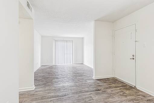 A room with a wooden floor and a white door.