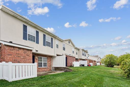 A row of houses with white picket fences.