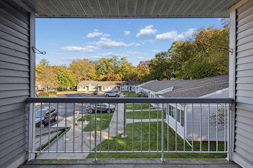 A view from a balcony overlooking a residential area.