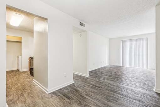 A room with a wooden floor and white walls.