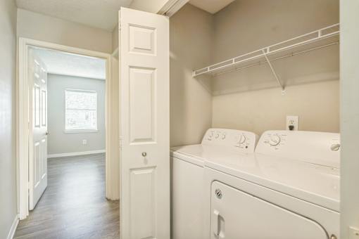 A white washer and dryer in a laundry room.