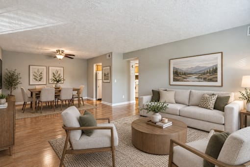 A living room with a couch, chairs, and a coffee table.