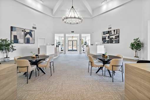 A modern dining room with a large table and chairs.