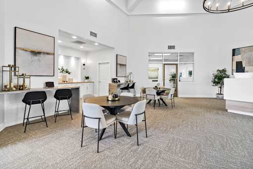A modern dining room with a round table and chairs.