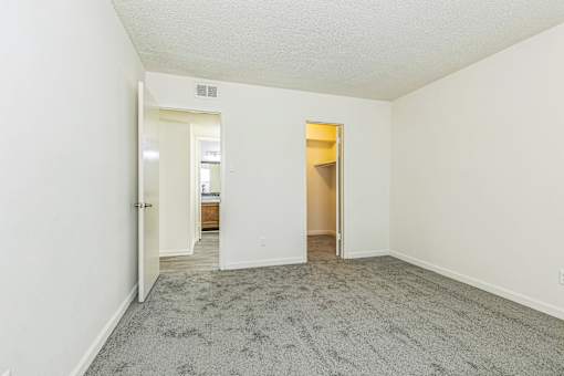 A room with a carpeted floor and white walls.
