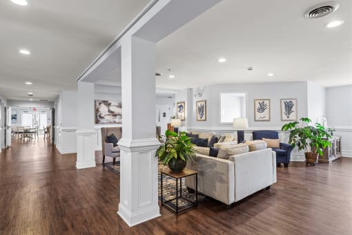 a living room with white walls and a hard wood floor
