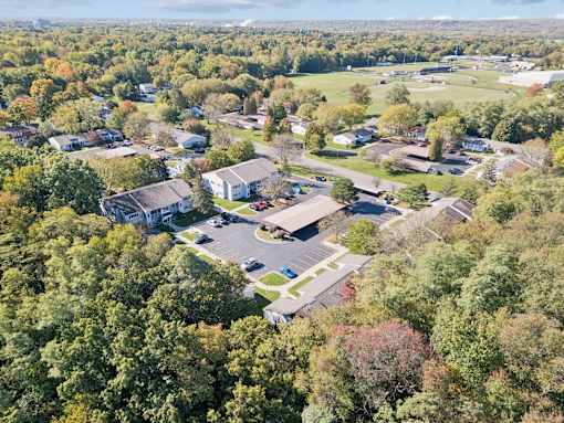 An aerial view of a residential area with houses and trees.