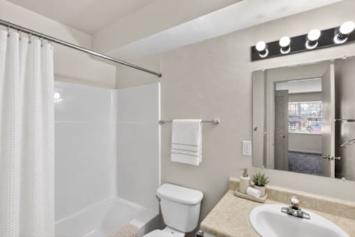 A white toilet sits next to a sink in a bathroom.