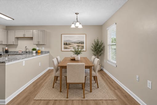 A dining room with a table set for four.