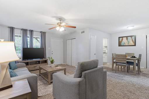 A living room with grey couches and a wooden coffee table.
