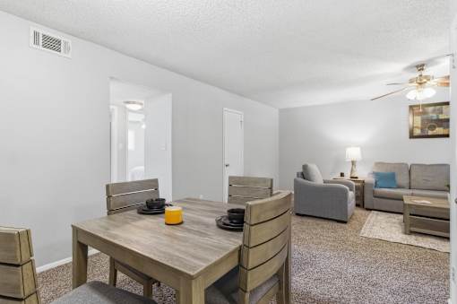 A dining room with a wooden table and chairs.