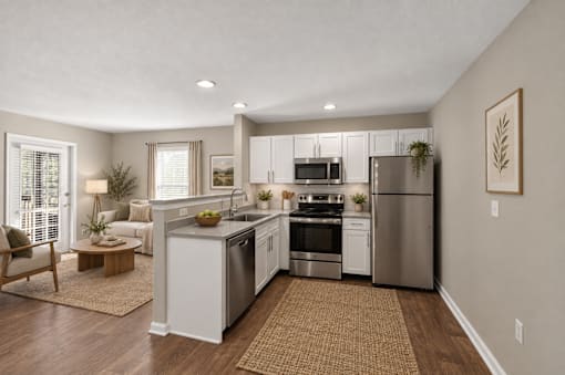 A modern kitchen with stainless steel appliances and wooden floors.
