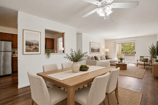A modern dining room with a wooden table and chairs.